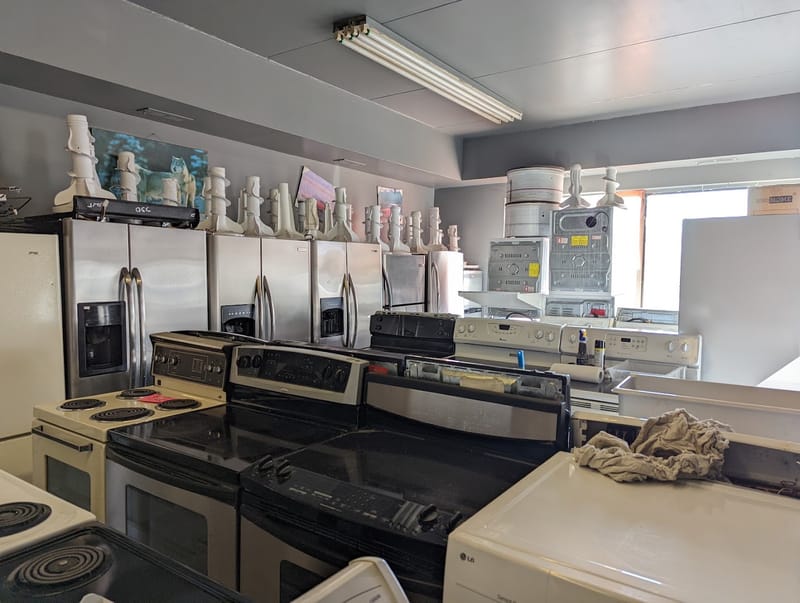 Showroom of stainless steel fridges and stoves at Moe's