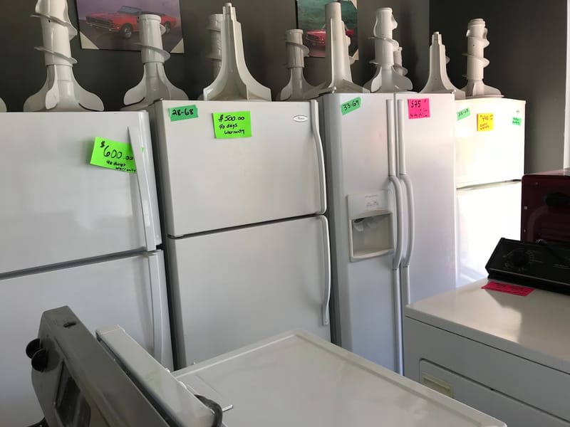 Tagged refurbished fridges with 90-day warranty labels