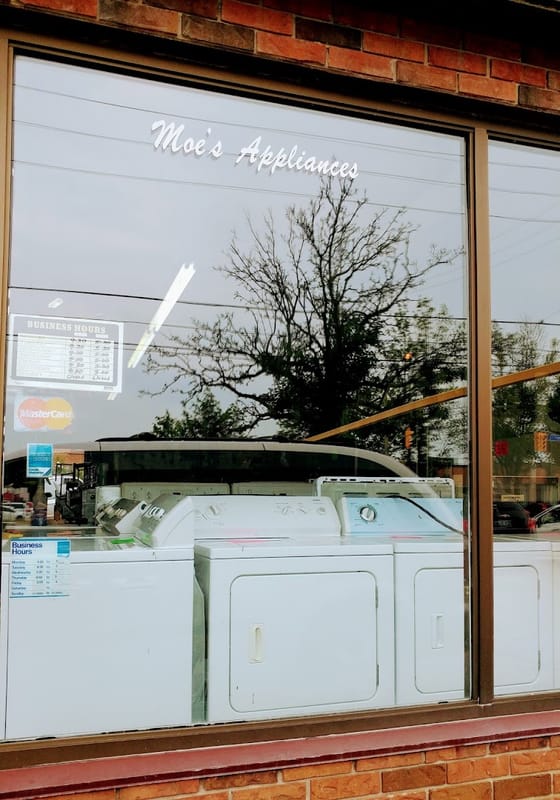 Moe's Appliances window lettering with washers on display